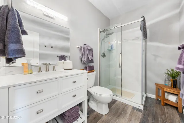 a bathroom with a sink a toilet and shower