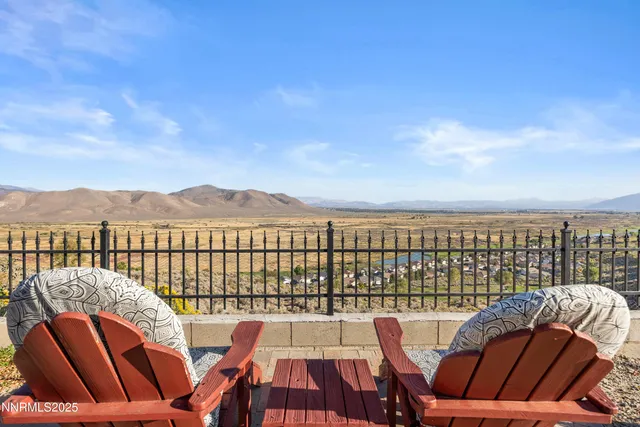 a balcony with wooden floor and city view
