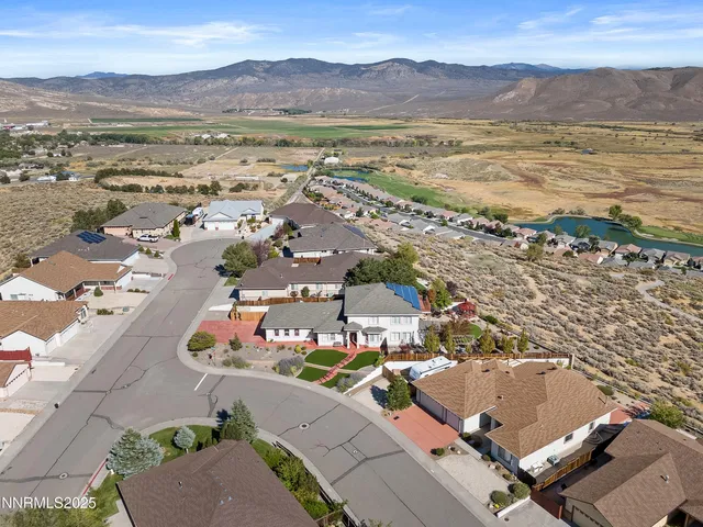an aerial view of residential houses with outdoor space