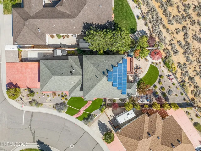 an aerial view of a house with a swimming pool
