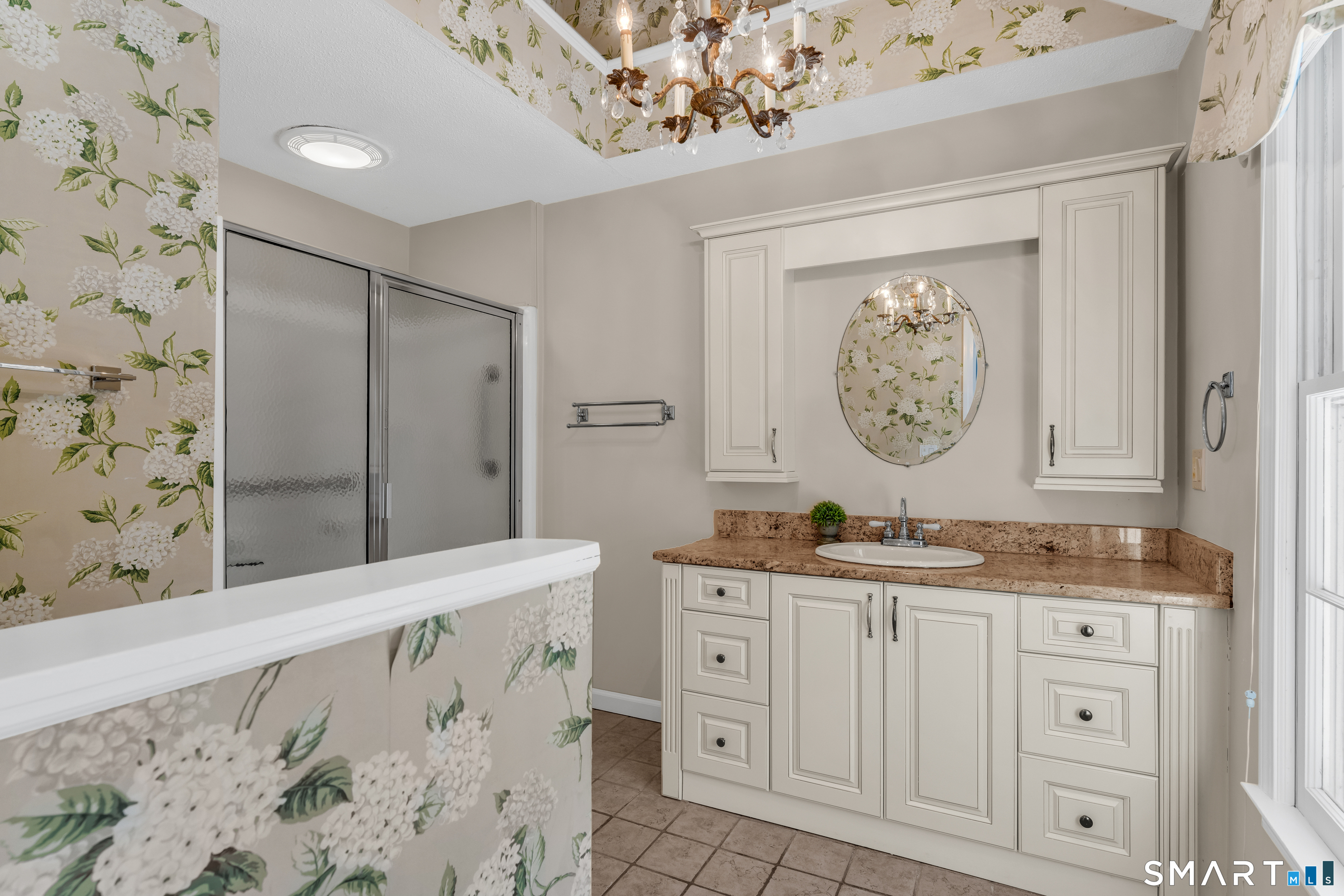 2 Esterly Farms Road, Unit 2 Madison, CT 06443 - Photo 14 of 40 a bathroom with a sink a vanity and a mirror