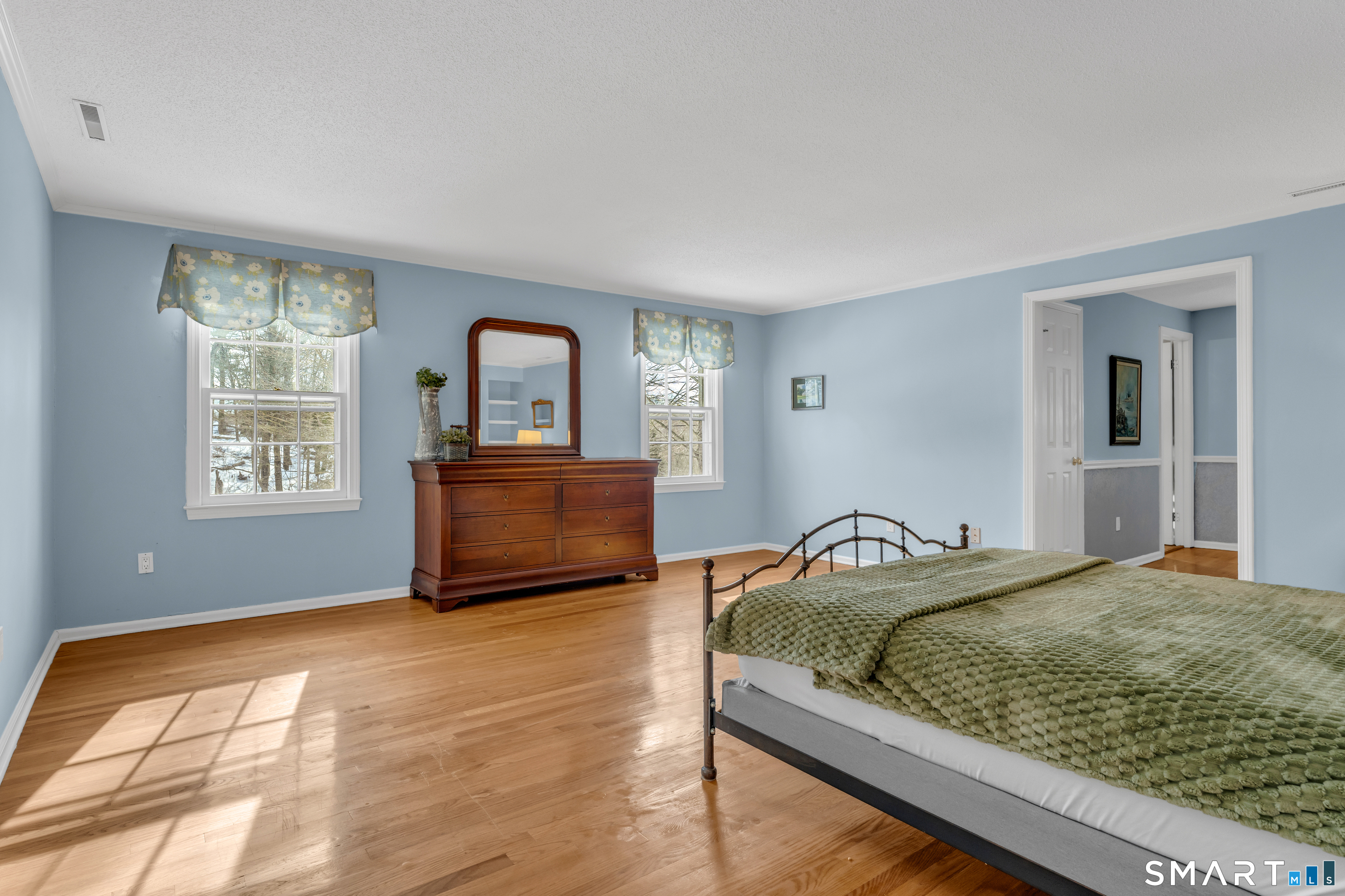 2 Esterly Farms Road, Unit 2 Madison, CT 06443 - Photo 13 of 40 Step into the expansive Primary Bedroom Suite on the second floor - this generously sized space impresses! Warm hardwood floors complement the elegant ambiance, creating a comfortable and sophisticated retreat. It's the ideal sanctuary for unwinding.