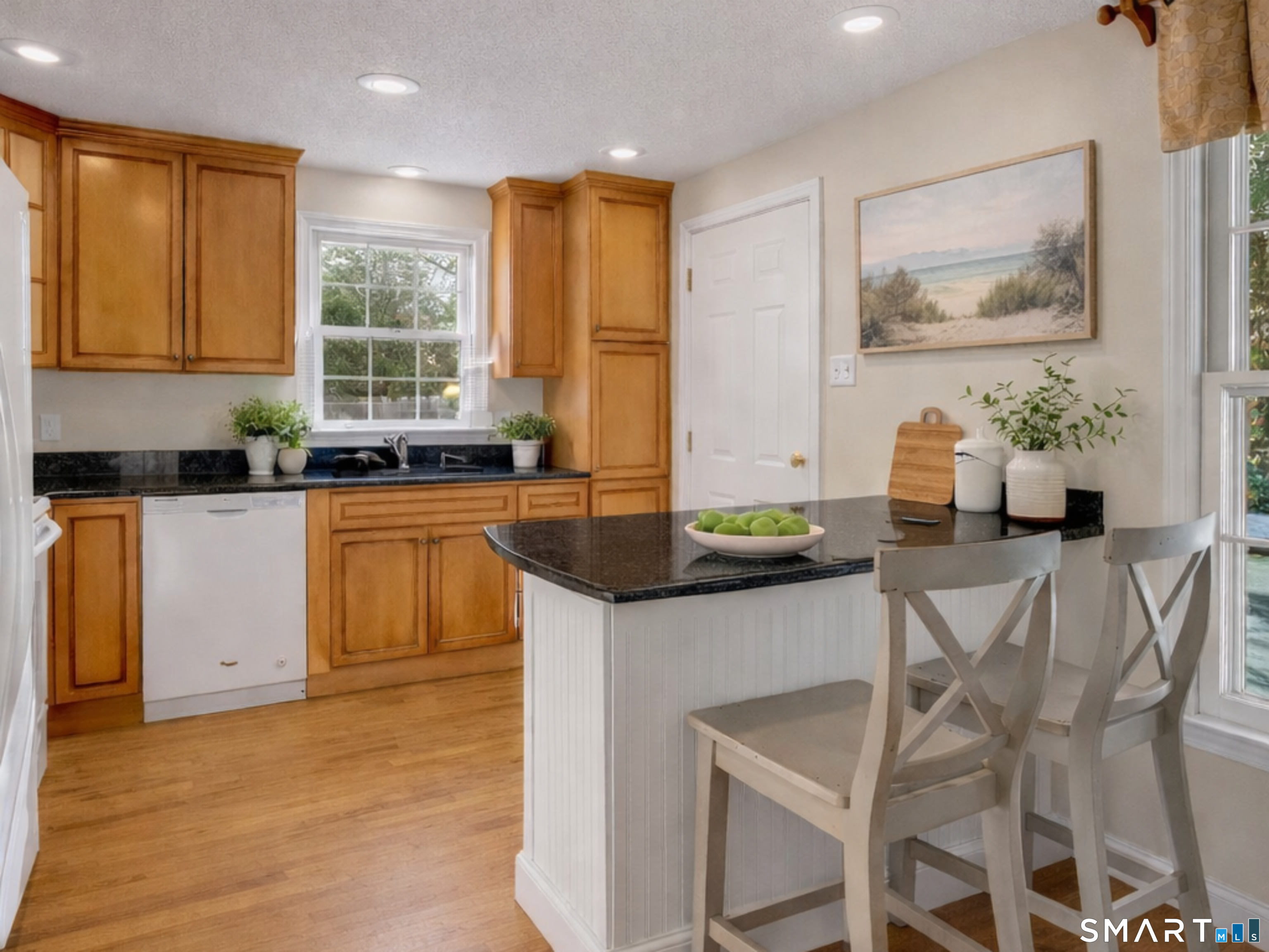 2 Esterly Farms Road, Unit 2 Madison, CT 06443 - Photo 21 of 40 a kitchen with granite countertop a sink and cabinets