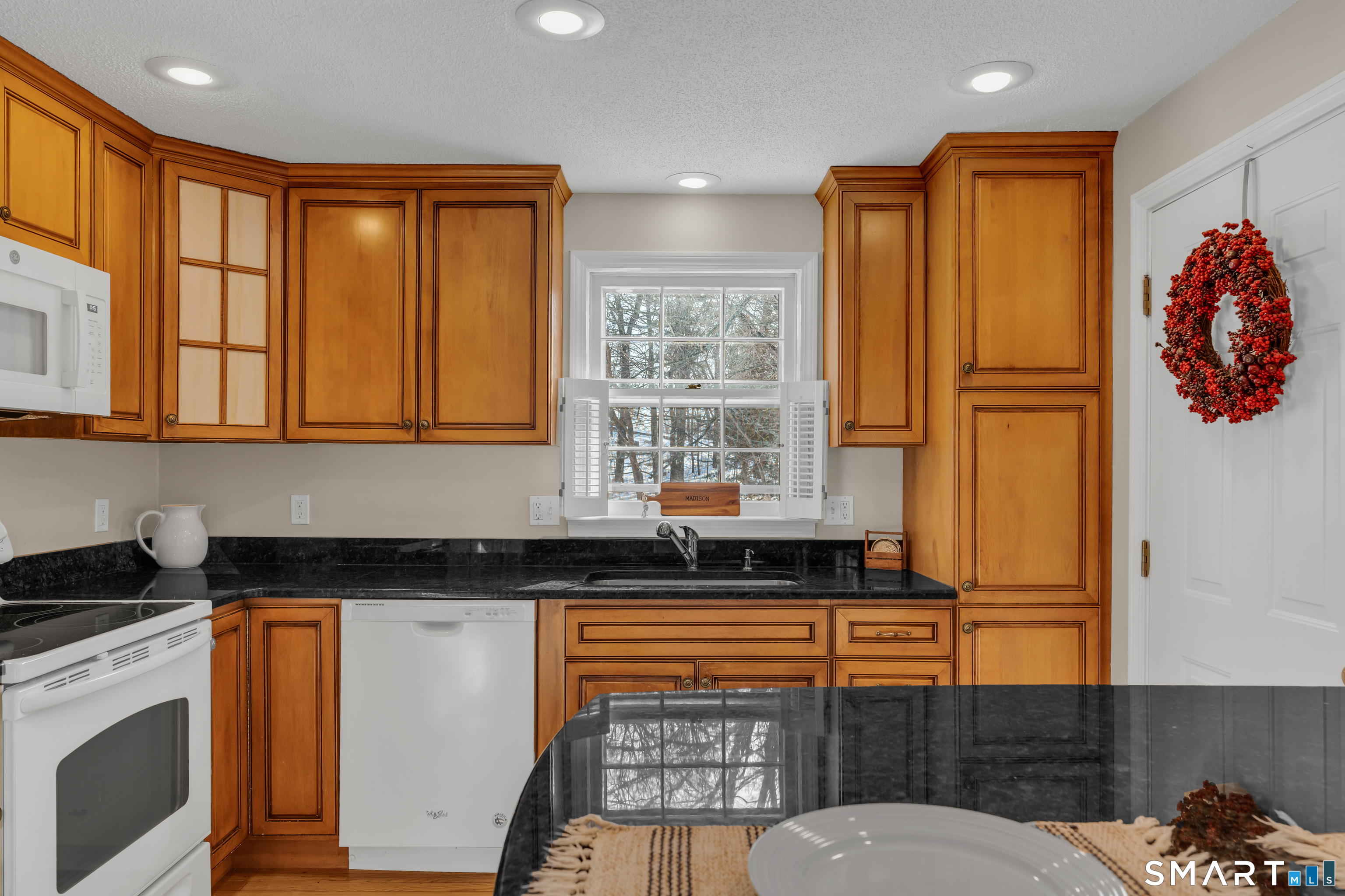 2 Esterly Farms Road, Unit 2 Madison, CT 06443 - Photo 22 of 40 a kitchen with stainless steel appliances granite countertop a stove a sink and a refrigerator
