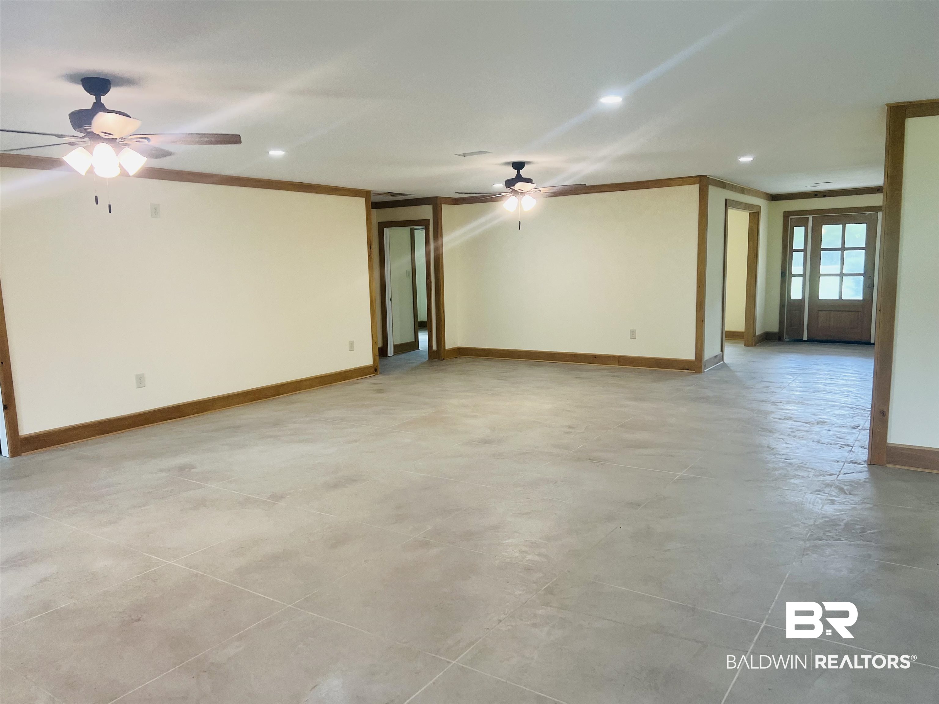 29685 Gardner Road Elberta, AL 36530 - Photo 6 of 16 Expansive interior space featuring light-toned walls with wood trim and baseboards