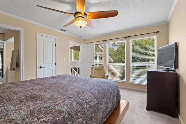 a bedroom with a large bed and a large window
