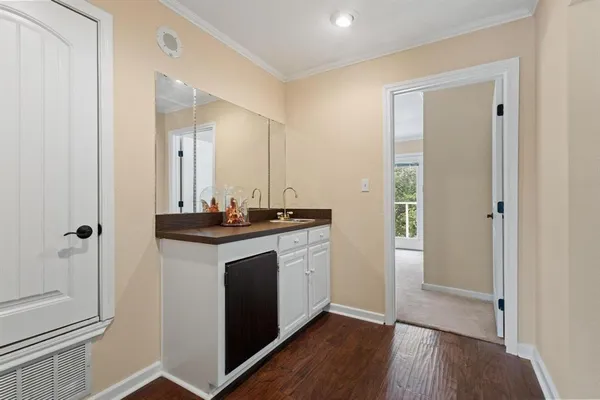 a kitchen with a sink and a mirror