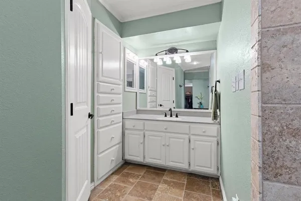 a spacious bathroom with a double vanity sink and a mirror