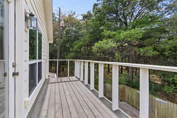 a view of a balcony with wooden floor