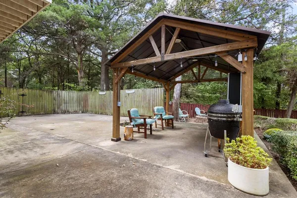 a backyard of a house with table and chairs