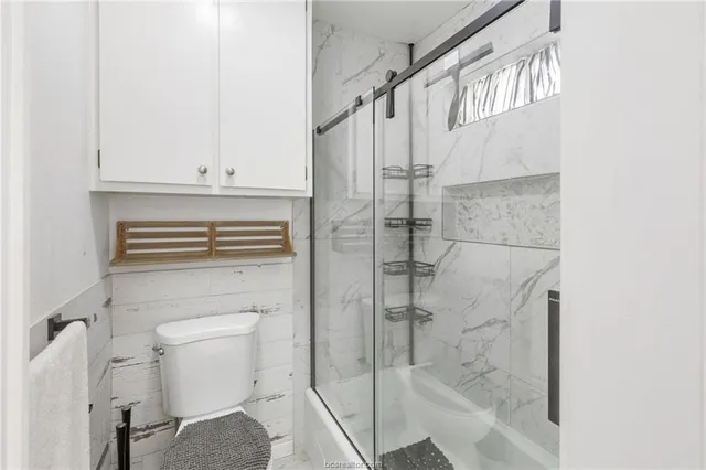 a bathroom with a shower and toilet