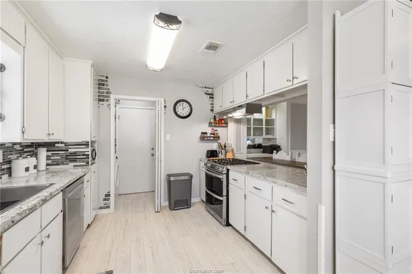 a kitchen with a sink stove and refrigerator