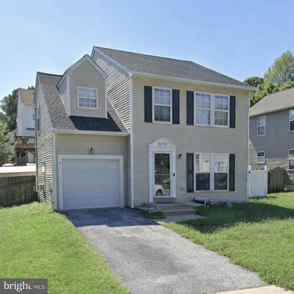 2209 227th Street Pasadena, MD 21122 - Photo 1 of 42 a front view of a house with a garden