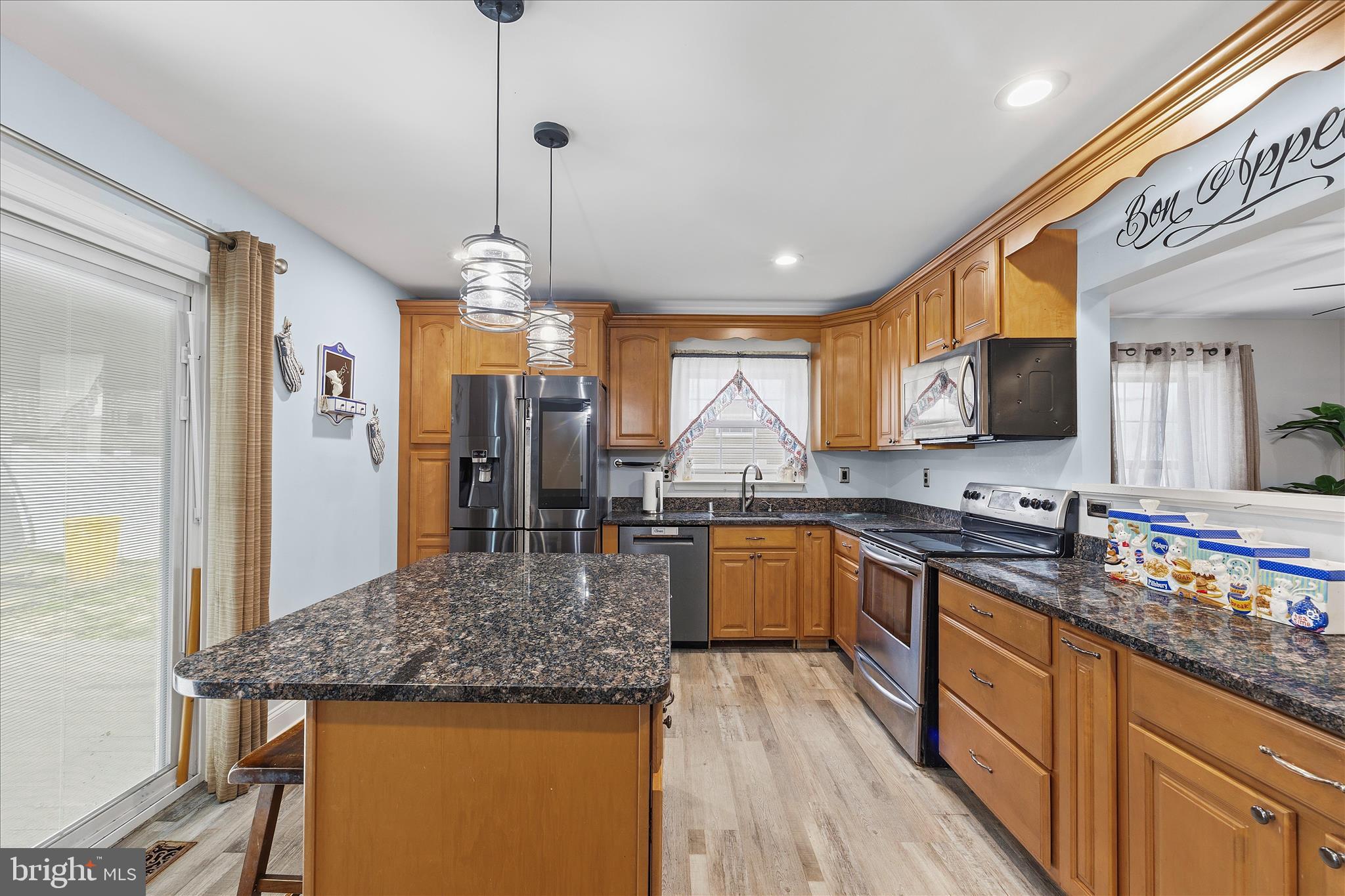 2209 227th Street Pasadena, MD 21122 - Photo 12 of 42 a kitchen with stainless steel appliances granite countertop a sink stove and refrigerator