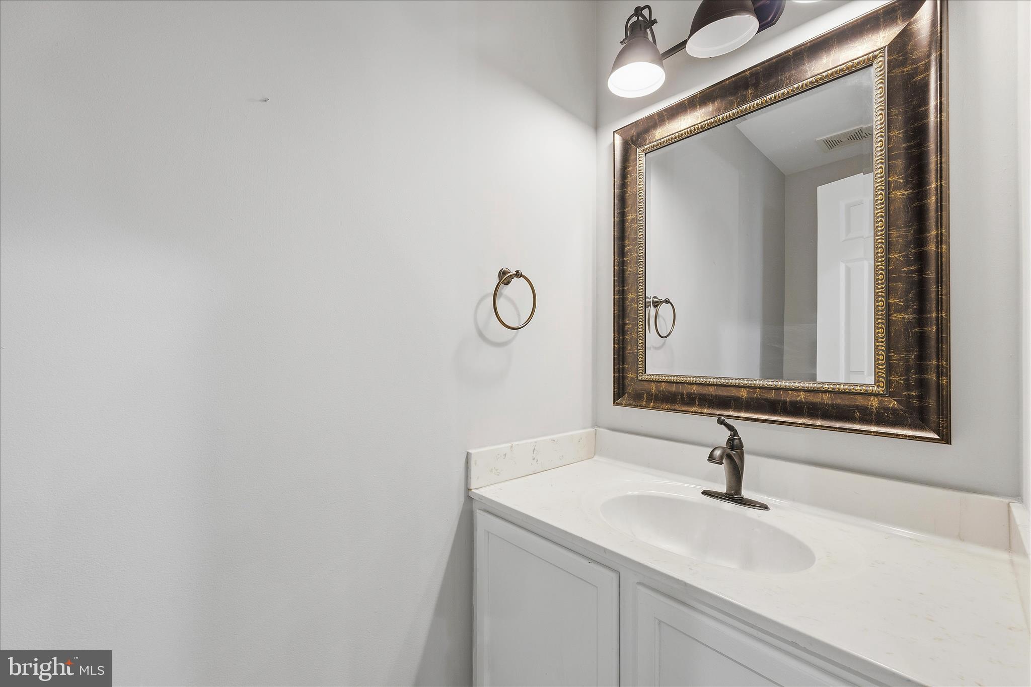 2209 227th Street Pasadena, MD 21122 - Photo 15 of 42 a bathroom with a sink and a mirror