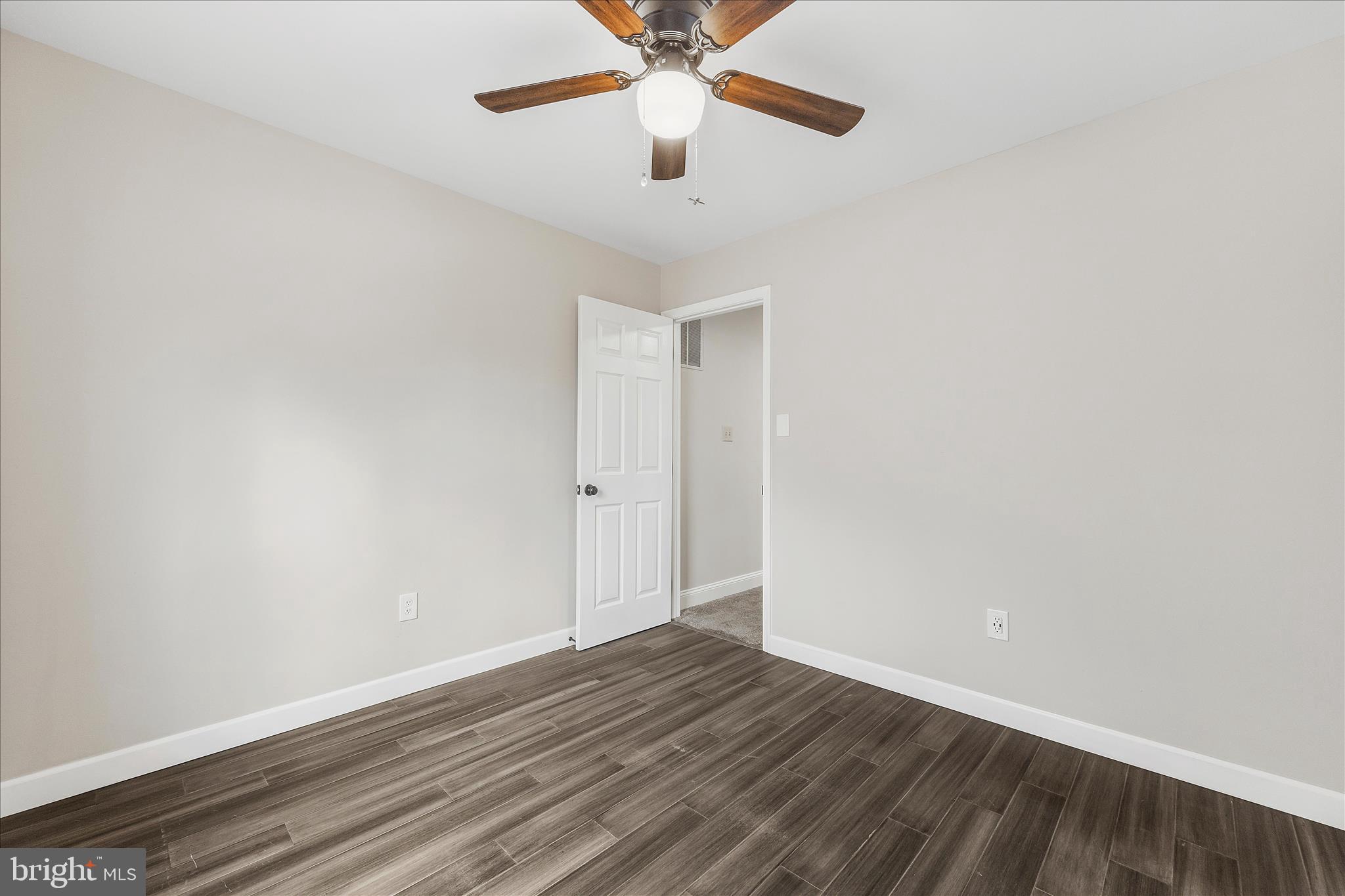 2209 227th Street Pasadena, MD 21122 - Photo 19 of 42 a view of an empty room with wooden floor