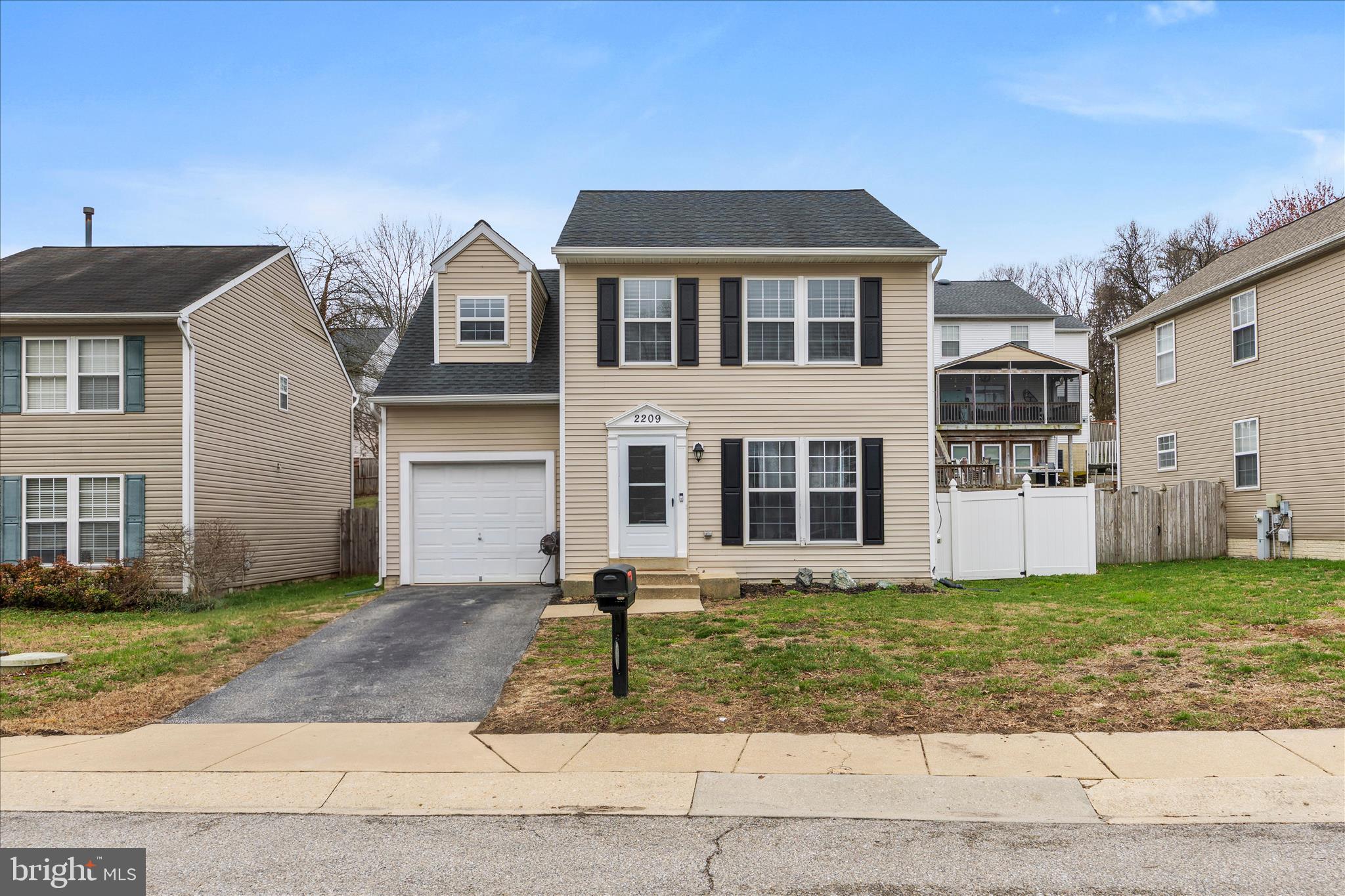 2209 227th Street Pasadena, MD 21122 - Photo 2 of 42 a front view of a house with a yard and garage