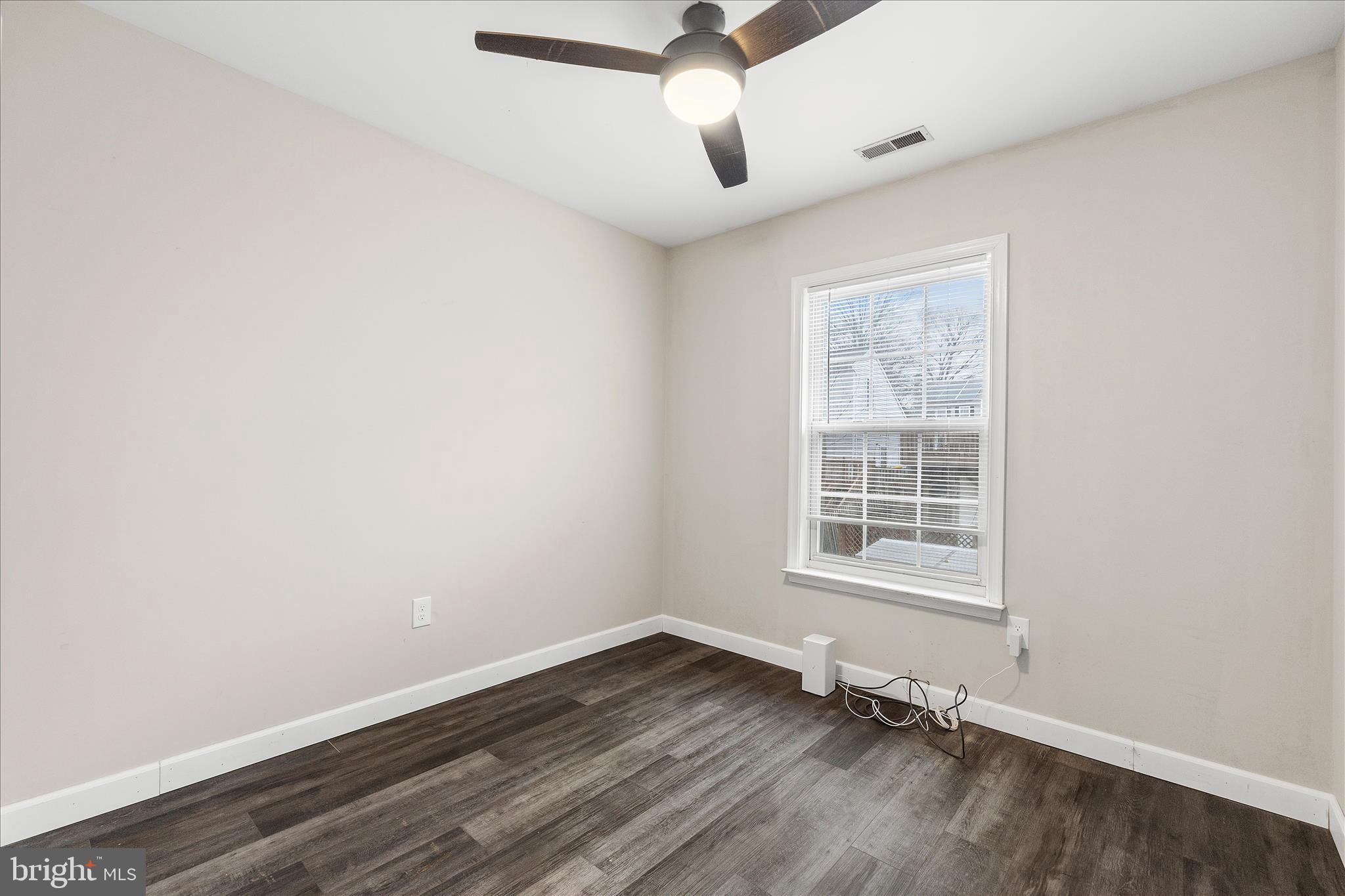 2209 227th Street Pasadena, MD 21122 - Photo 22 of 42 an empty room with wooden floor and windows