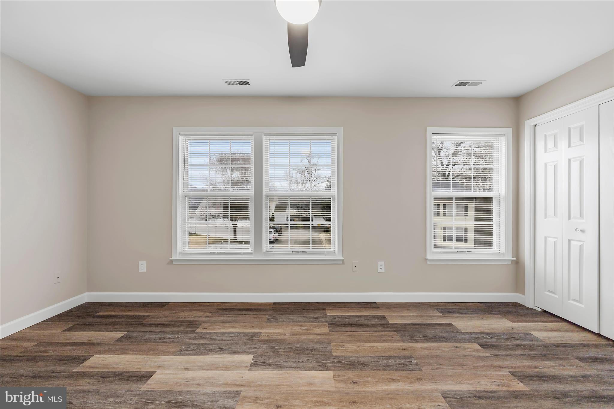 2209 227th Street Pasadena, MD 21122 - Photo 26 of 42 a view of an empty room with wooden floor and window