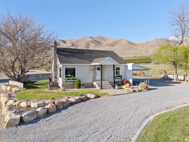 115 East 1600th Street North Santaquin, UT 84655 - Photo 2 of 52 Light-colored brick exterior featuring a covered front entry and a gravel driveway