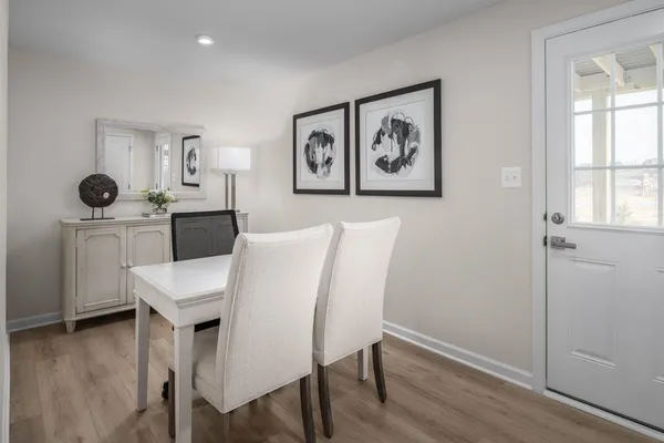a view of a dining room with furniture and wooden floor