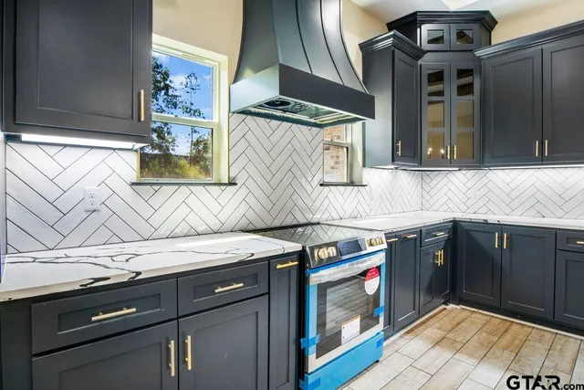 a kitchen with stainless steel appliances granite countertop a stove and a sink
