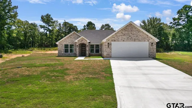 a front view of a house with yard