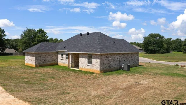 a front view of a house with a garden and yard