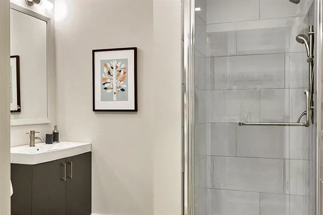 a bathroom with a shower and a sink