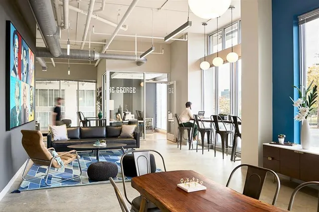 a living room with lots of furniture and a large window