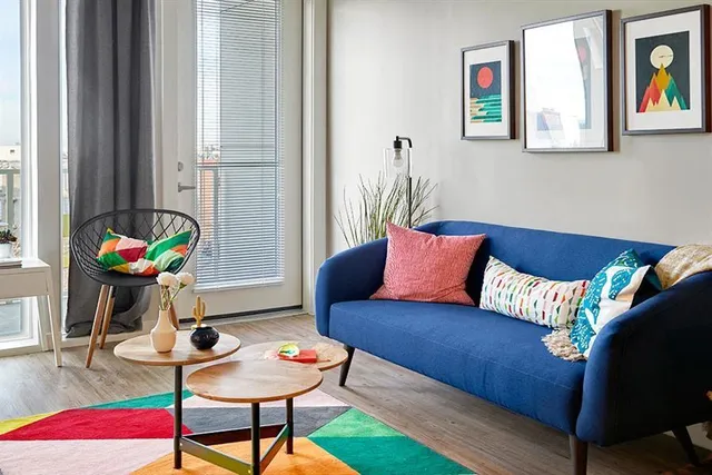 a living room with furniture and a potted plant