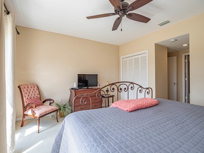 5075 Harmony Circle, Unit 302 Vero Beach, FL 32967 - Photo 17 of 32 a bedroom with a bed couch and a window