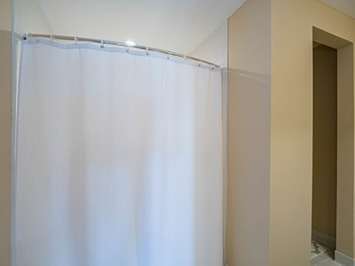 5075 Harmony Circle, Unit 302 Vero Beach, FL 32967 - Photo 19 of 32 a bathroom with a shower and a shower curtain