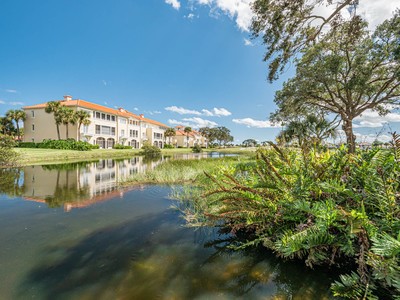 5075 Harmony Circle, Unit 302 Vero Beach, FL 32967 - Photo 2 of 32 a view of a lake with a big yard