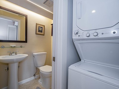 5075 Harmony Circle, Unit 302 Vero Beach, FL 32967 - Photo 23 of 32 a bathroom with a toilet sink and mirror