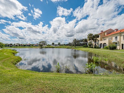 5075 Harmony Circle, Unit 302 Vero Beach, FL 32967 - Photo 28 of 32 a view of a lake with a big yard