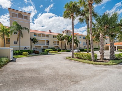 5075 Harmony Circle, Unit 302 Vero Beach, FL 32967 - Photo 3 of 32 front view of a house with a garden