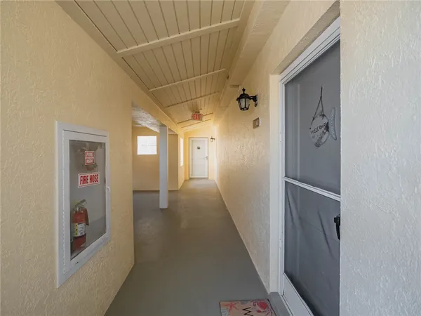 a living room with furniture large window and flat screen tv