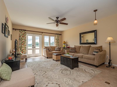 5075 Harmony Circle, Unit 302 Vero Beach, FL 32967 - Photo 8 of 32 a living room with furniture large window and flat screen tv