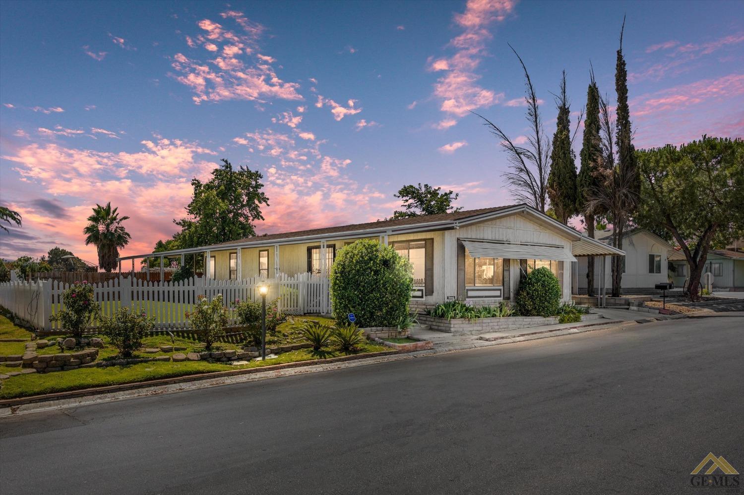 a front view of a house with a yard and street view