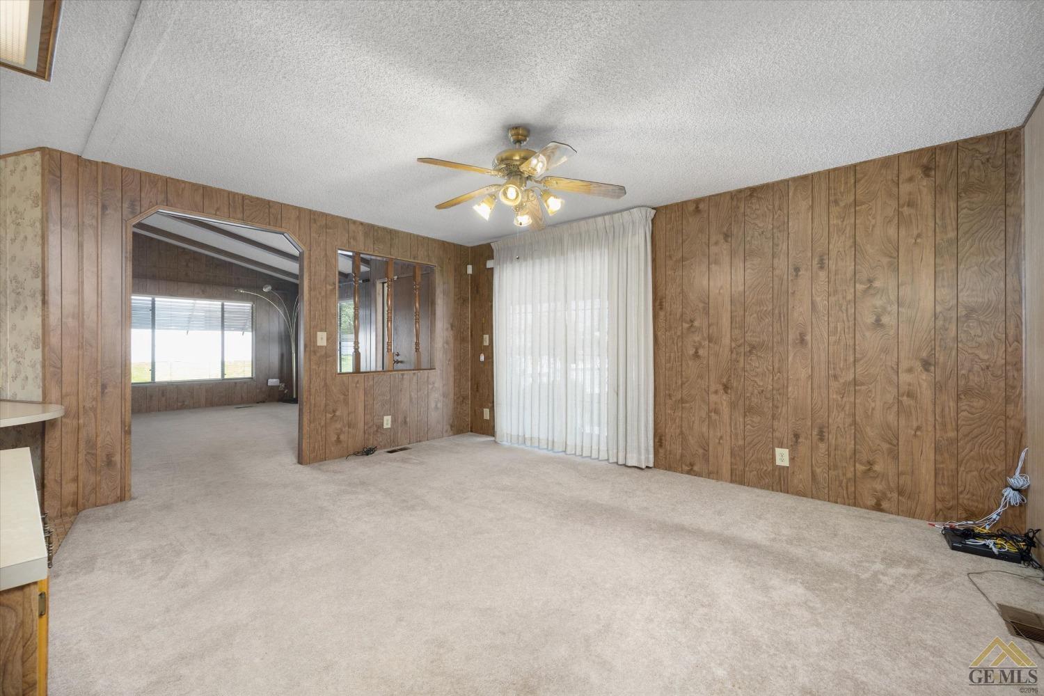 Undisclosed Address Bakersfield, CA 93306 - Photo 12 of 32 a view of an empty room and a ceiling fan