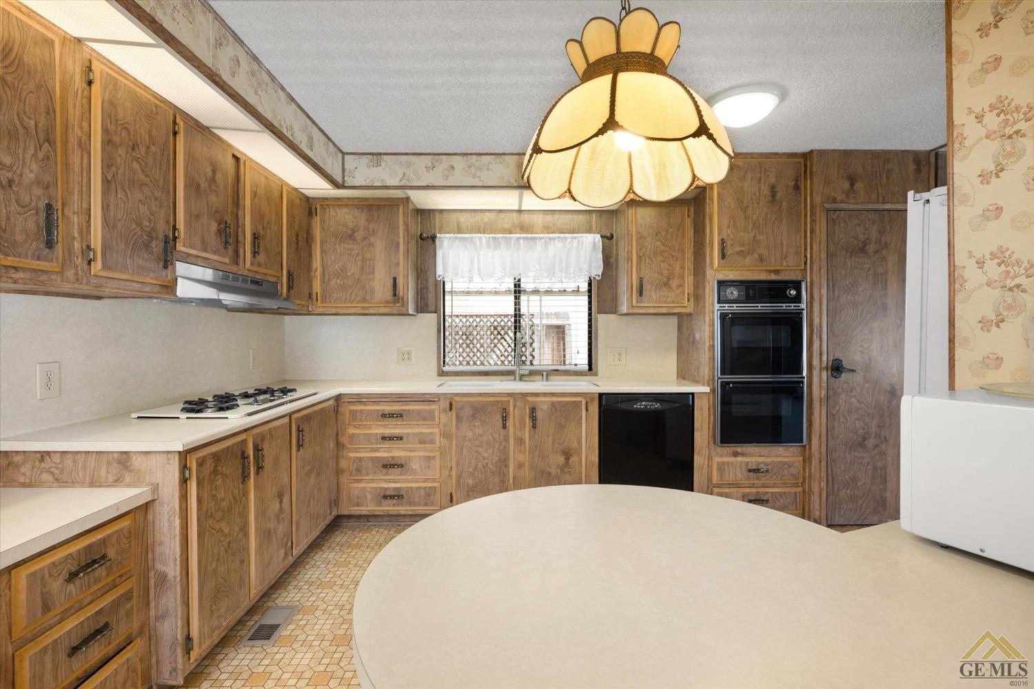 Undisclosed Address Bakersfield, CA 93306 - Photo 14 of 32 a kitchen with a cabinets a stove and a window