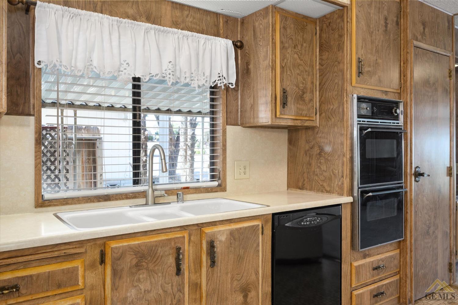 Undisclosed Address Bakersfield, CA 93306 - Photo 15 of 32 a kitchen with a refrigerator and countertop