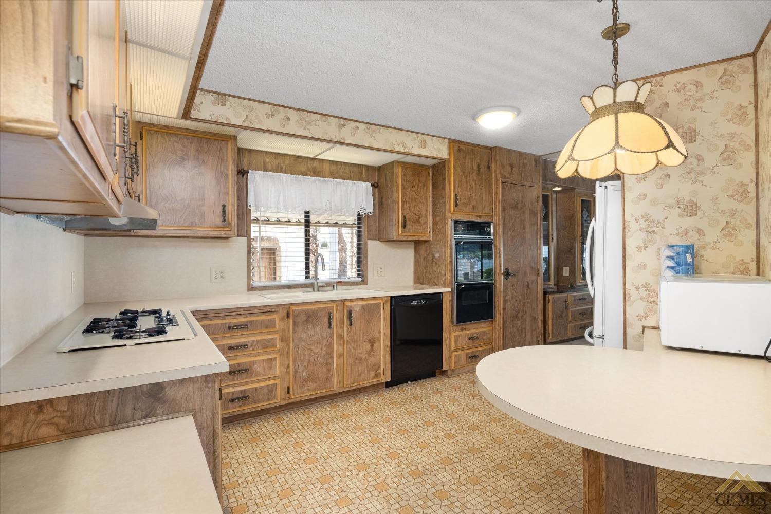 Undisclosed Address Bakersfield, CA 93306 - Photo 16 of 32 a kitchen with stainless steel appliances granite countertop a sink a stove and a refrigerator