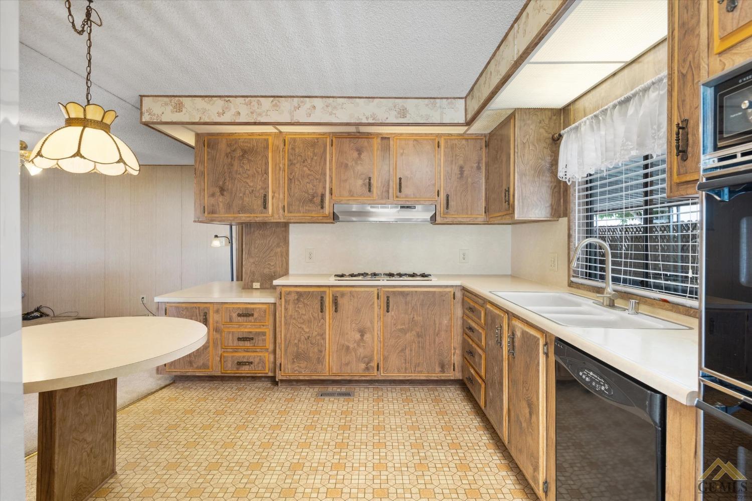 Undisclosed Address Bakersfield, CA 93306 - Photo 17 of 32 a kitchen with a sink stove and cabinets