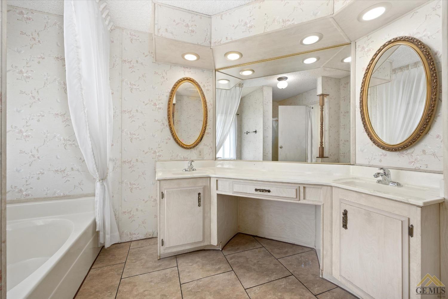 Undisclosed Address Bakersfield, CA 93306 - Photo 20 of 32 a bathroom with a sink and a mirror
