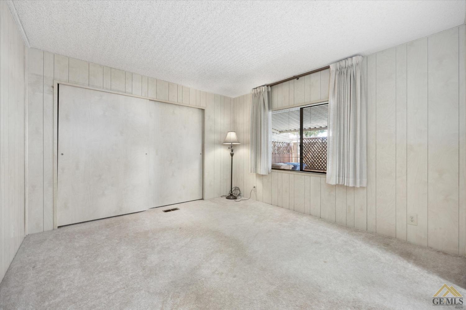 Undisclosed Address Bakersfield, CA 93306 - Photo 22 of 32 a view of an empty room with closet and a bathroom
