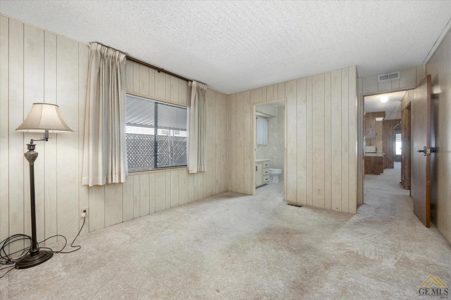 Undisclosed Address Bakersfield, CA 93306 - Photo 23 of 32 a view of a room with an empty space and wooden floor