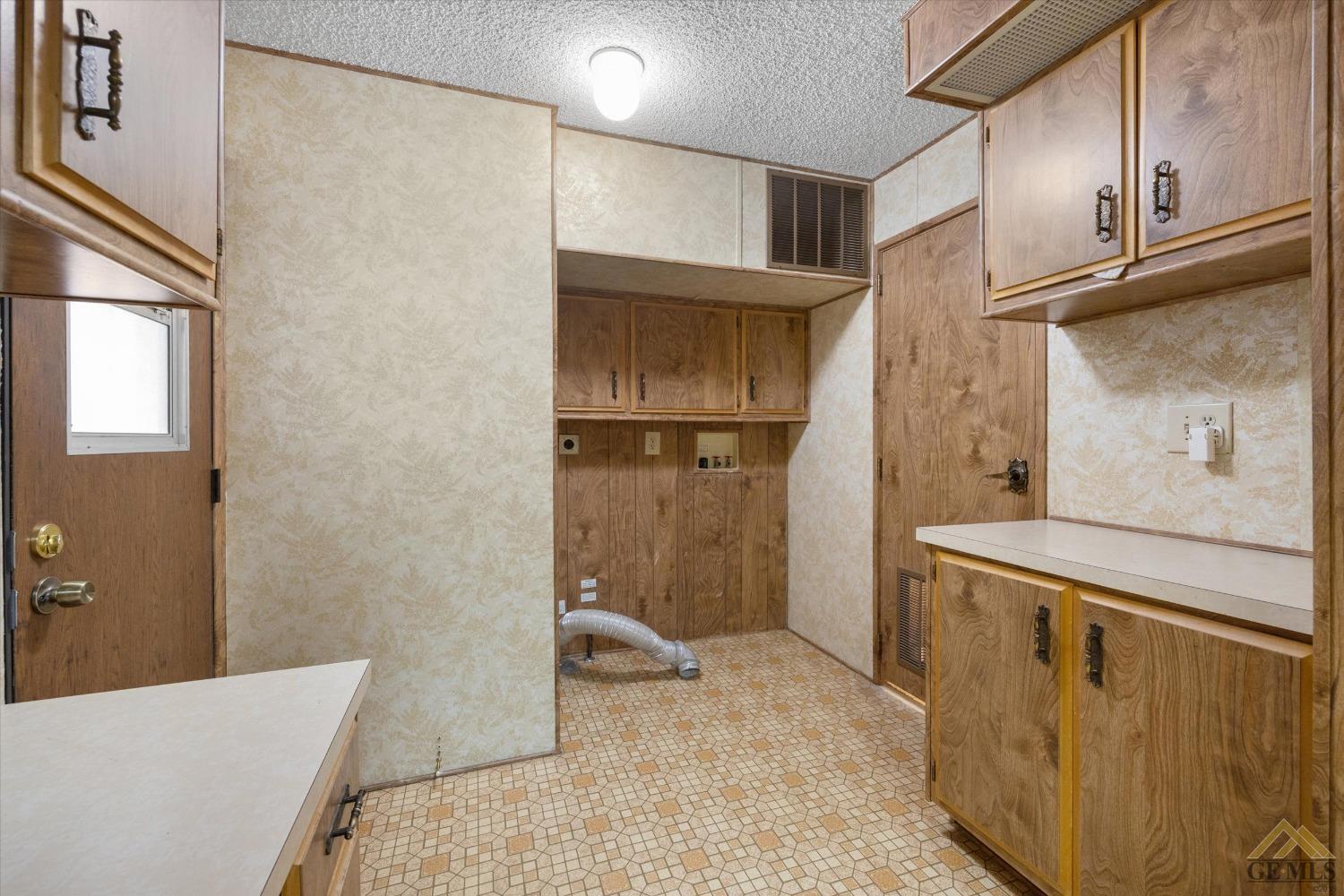 Undisclosed Address Bakersfield, CA 93306 - Photo 25 of 32 a kitchen with a refrigerator and cabinets