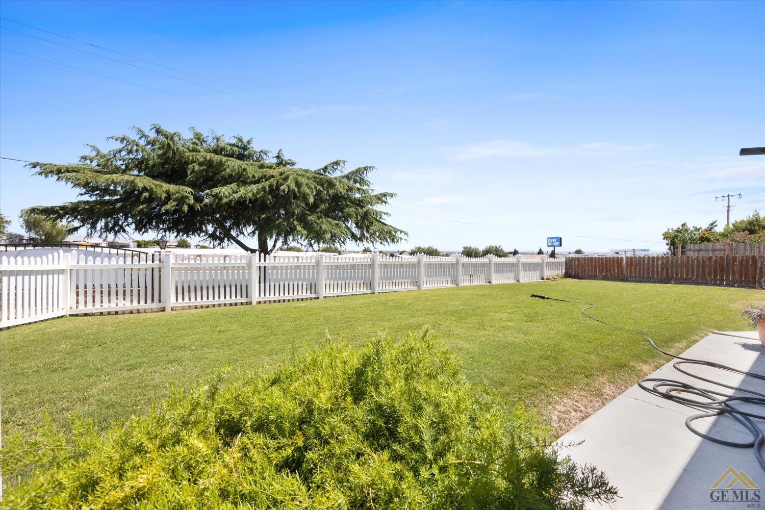 Undisclosed Address Bakersfield, CA 93306 - Photo 28 of 32 a view of a garden and basketball court